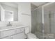 Bathroom with a glass-enclosed shower, neutral tile, and a modern vanity at 15034 Scoter St, Charlotte, NC 28262