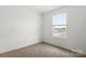 Bedroom with a large window and neutral carpet at 15034 Scoter St, Charlotte, NC 28262