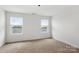 Bright bedroom with two large windows, neutral carpet, and ample natural light at 15034 Scoter St, Charlotte, NC 28262