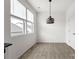 Bright dining area featuring hardwood floors, natural light, and a stylish pendant light at 15034 Scoter St, Charlotte, NC 28262