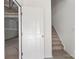 Bright entryway showcasing a staircase and a door leading to an unfinished basement at 15034 Scoter St, Charlotte, NC 28262