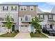 Charming townhome featuring a balcony, attached garage, and manicured lawn, showcasing a modern design at 15034 Scoter St, Charlotte, NC 28262