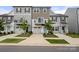New construction townhomes featuring attached garages, modern design, and a clean, landscaped frontage at 15034 Scoter St, Charlotte, NC 28262
