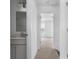 Hallway view to bedroom with bathroom vanity, neutral colors and natural light at 15034 Scoter St, Charlotte, NC 28262