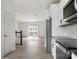 Bright kitchen with stainless steel appliances, white cabinets, and an open view to the living room at 15034 Scoter St, Charlotte, NC 28262