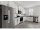 Modern kitchen with stainless steel appliances, white cabinets, and dark countertops at 15034 Scoter St, Charlotte, NC 28262