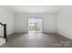 Inviting living room with sliding glass doors that bring in light, and stylish hardwood floors at 15034 Scoter St, Charlotte, NC 28262