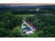 Expansive home with a pool and manicured grounds nestled in a lush, green landscape at 15037 June Washam Rd, Davidson, NC 28036
