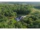 An estate featuring a pool surrounded by lush greenery and trees at 15037 June Washam Rd, Davidson, NC 28036