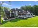 Backyard with a manicured lawn and garden, and a large in-ground pool at 15037 June Washam Rd, Davidson, NC 28036