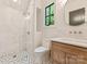 Modern bathroom featuring a glass-enclosed shower, sleek fixtures, and stylish tile flooring at 15037 June Washam Rd, Davidson, NC 28036
