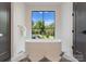 Modern bathtub with a view of the backyard at 15037 June Washam Rd, Davidson, NC 28036