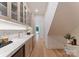 Butler's pantry with marble countertops, glass-front cabinets, and stainless steel appliances at 15037 June Washam Rd, Davidson, NC 28036