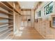Spacious walk-in closet with custom wood shelving and drawers offers ample storage at 15037 June Washam Rd, Davidson, NC 28036