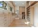 Beautiful walk-in closet features custom cabinetry, shelving, and a built-in desk area at 15037 June Washam Rd, Davidson, NC 28036
