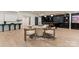 Bright dining area featuring a round table, modern chairs, and a zebra-striped rug adjacent to a bar area at 15037 June Washam Rd, Davidson, NC 28036