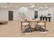 Bright dining area featuring a round table, modern chairs, and an elegant zebra-striped rug on light hardwood floors at 15037 June Washam Rd, Davidson, NC 28036