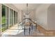 Bright dining room featuring ample natural light, designer chandelier, and a neutral color palette at 15037 June Washam Rd, Davidson, NC 28036