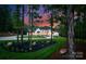 Elegant home framed by mature trees and lush landscaping at 15037 June Washam Rd, Davidson, NC 28036