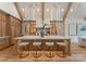 Gourmet kitchen with a large island, marble countertops, designer lighting, and hardwood floors at 15037 June Washam Rd, Davidson, NC 28036