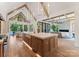 Open kitchen with island, marble counters, and seamless flow to living and dining areas at 15037 June Washam Rd, Davidson, NC 28036