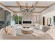 Comfortable living room with a stone fireplace, coffered ceilings, and ample seating at 15037 June Washam Rd, Davidson, NC 28036