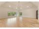 Open living room with hardwood floors, high ceilings, and large windows offer great views at 15037 June Washam Rd, Davidson, NC 28036