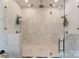 Contemporary all-stone shower with glass door and dual shower heads at 15037 June Washam Rd, Davidson, NC 28036