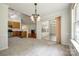 Open dining area features a modern light fixture and glass patio door to the sunroom at 1520 Deer Forest Dr, Fort Mill, SC 29707