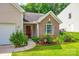 Inviting front entrance with brick accents, lush landscaping, and a welcoming walkway at 1520 Deer Forest Dr, Fort Mill, SC 29707