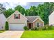 Charming home featuring a well-manicured lawn, attached garage, and a mix of brick and siding exterior at 1520 Deer Forest Dr, Fort Mill, SC 29707