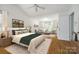 Bright main bedroom featuring hardwood floors, a ceiling fan, and a sitting area with couches for relaxation at 1520 Deer Forest Dr, Fort Mill, SC 29707