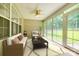 Bright sunroom featuring lots of windows to view the backyard, a ceiling fan, and comfortable seating at 1520 Deer Forest Dr, Fort Mill, SC 29707