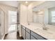 Bathroom featuring double sinks, modern fixtures, and an adjacent room with hardwood floors at 1530 Cottage Creek Dr, Bessemer City, NC 28016