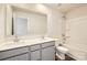 Bright bathroom featuring double sink vanity and combination tub and shower at 1530 Cottage Creek Dr, Bessemer City, NC 28016