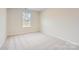 Light and airy bedroom with neutral carpeting and a window offering natural light at 1530 Cottage Creek Dr, Bessemer City, NC 28016