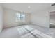 Bright, carpeted bedroom with a large window offering plenty of natural light at 1530 Cottage Creek Dr, Bessemer City, NC 28016
