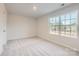 Carpeted bedroom with a large window providing plenty of natural light and a peaceful view at 1530 Cottage Creek Dr, Bessemer City, NC 28016