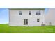 A view of the backyard showing the lawn and the back of the home's exterior at 1547 Cottage Creek Dr, Bessemer City, NC 28016