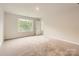 Spacious bedroom with a large window providing natural light and plush carpeting at 1547 Cottage Creek Dr, Bessemer City, NC 28016