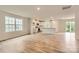 Open-concept living room featuring wood-look floors, modern lighting, and ample natural light at 1547 Cottage Creek Dr, Bessemer City, NC 28016