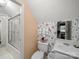Cozy bathroom featuring floral wallpaper, a shower with glass doors, and a small white vanity at 1634 - B Union Rd, Gastonia, NC 28054