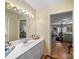 Bright bathroom featuring a white vanity, a large mirror with lights, and an open doorway to the bedroom at 1634 - B Union Rd, Gastonia, NC 28054
