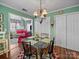 Charming dining area with a glass table, decorative rug, and a view into the living room at 1634 - B Union Rd, Gastonia, NC 28054