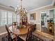 Elegant dining room with a chandelier, wooden table, and view to kitchen, perfect for Gathering gatherings at 1634 - B Union Rd, Gastonia, NC 28054