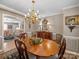 Warm dining room with wood table, chandelier, and access to a living area, enhancing the home's charm at 1634 - B Union Rd, Gastonia, NC 28054
