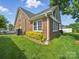 Brick home exterior with a well-maintained lawn, attractive landscaping, and visible air conditioning unit at 1634 - B Union Rd, Gastonia, NC 28054
