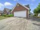 Home exterior with a driveway leading to a garage and an outdoor seating area with table and chairs at 1634 - B Union Rd, Gastonia, NC 28054