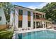 An inviting backyard features a sleek pool with spa, stylish seating, and manicured landscaping, perfect for entertaining at 2121 Laburnum Ave, Charlotte, NC 28205