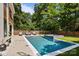 Resort-style backyard with sleek pool, spa, and lounge area surrounded by a manicured yard at 2121 Laburnum Ave, Charlotte, NC 28205